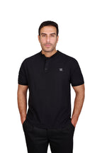 Rflx Reflection Polo, a cotton knit polo with a ribbed mandarin band collar, in black, three-quarter view showing the shoulder and ribbed cuff