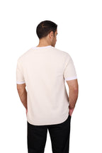Rflx Reflection Polo, a cotton knit polo with a ribbed mandarin band collar, in cream with white ribbed trim, back view showing the plain body and curved hem