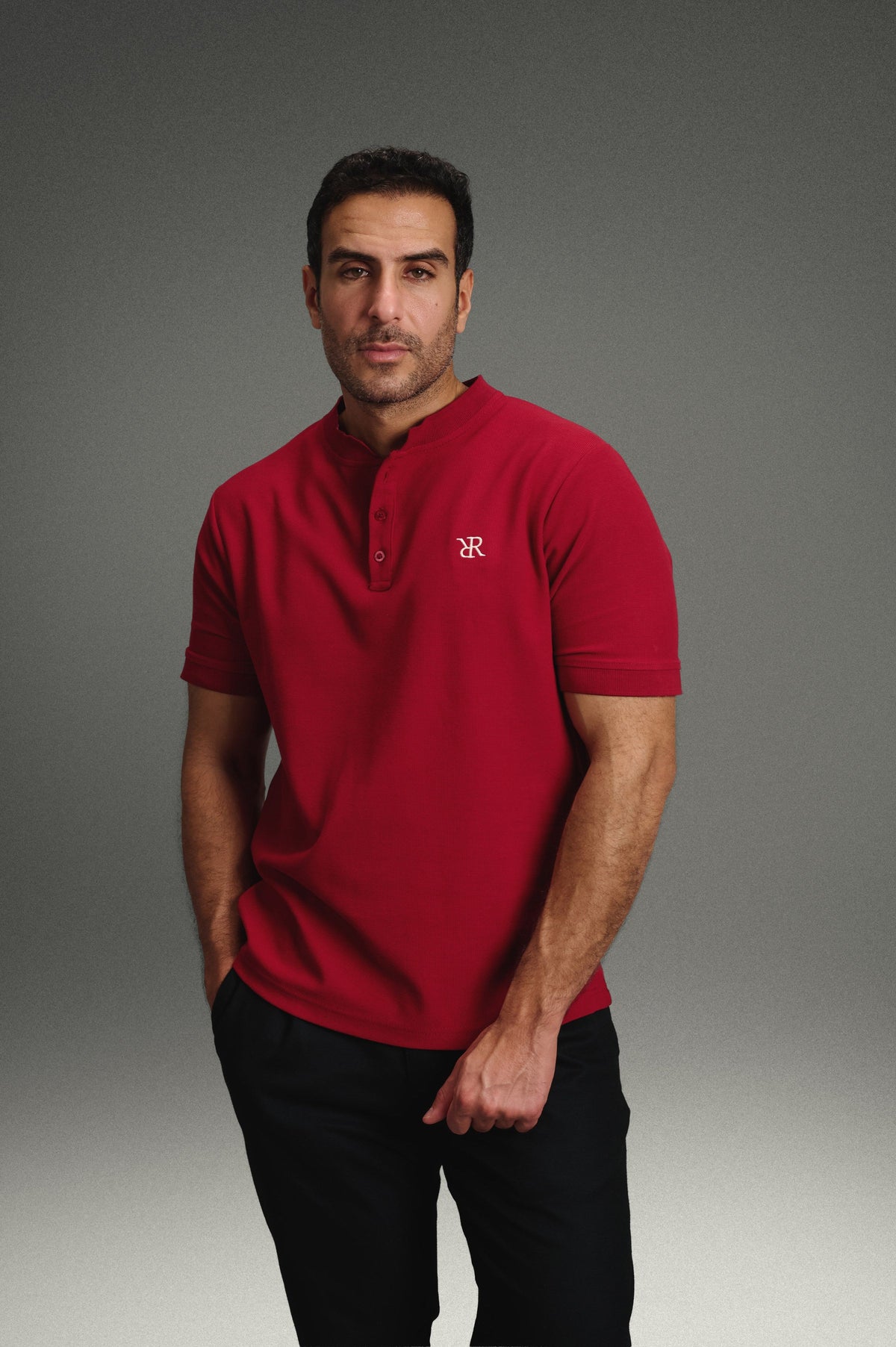Rflx Reflection Polo in crimson, standing three-quarter, looking to camera