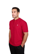 Rflx Reflection Polo, a cotton knit polo with a ribbed mandarin band collar, in crimson, three-quarter view showing the shoulder and ribbed cuff