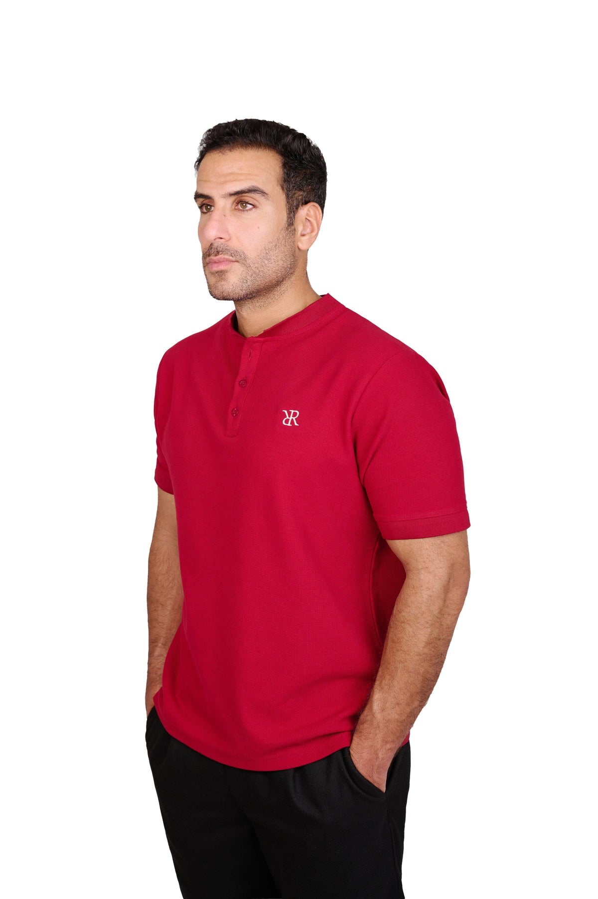 Rflx Reflection Polo, a cotton knit polo with a ribbed mandarin band collar, in crimson, three-quarter view showing the shoulder and ribbed cuff
