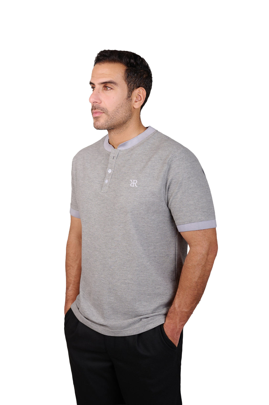 Rflx Reflection Polo, a cotton knit polo with a ribbed mandarin band collar, in heather grey with lilac ribbed trim, three-quarter view showing the shoulder and ribbed cuff