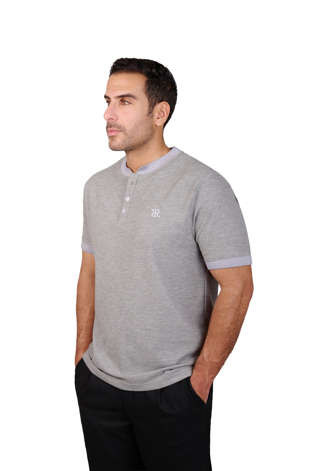 Rflx Reflection Polo, a cotton knit polo with a ribbed mandarin band collar, in heather grey with lilac ribbed trim, three-quarter view showing the shoulder and ribbed cuff