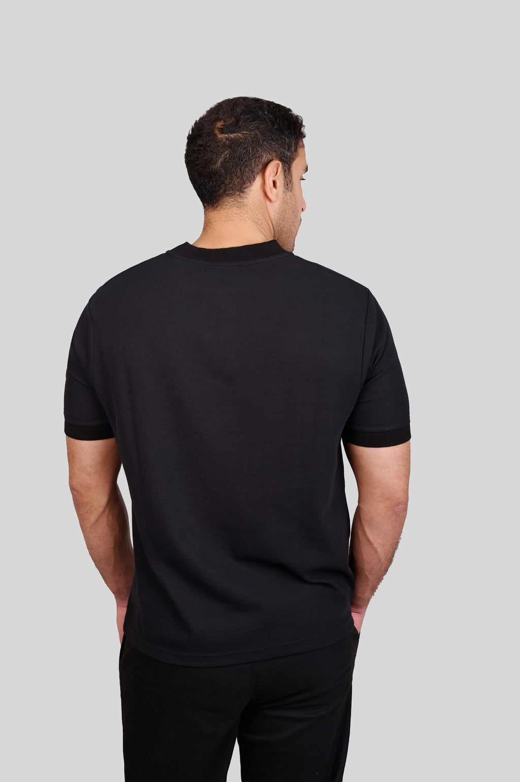 Rflx waffle-knit mandarin collar henley tee in black, back view showing the plain body and ribbed collar