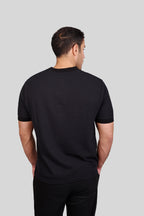 Rflx waffle-knit mandarin collar henley tee in black, back view showing the plain body and ribbed collar