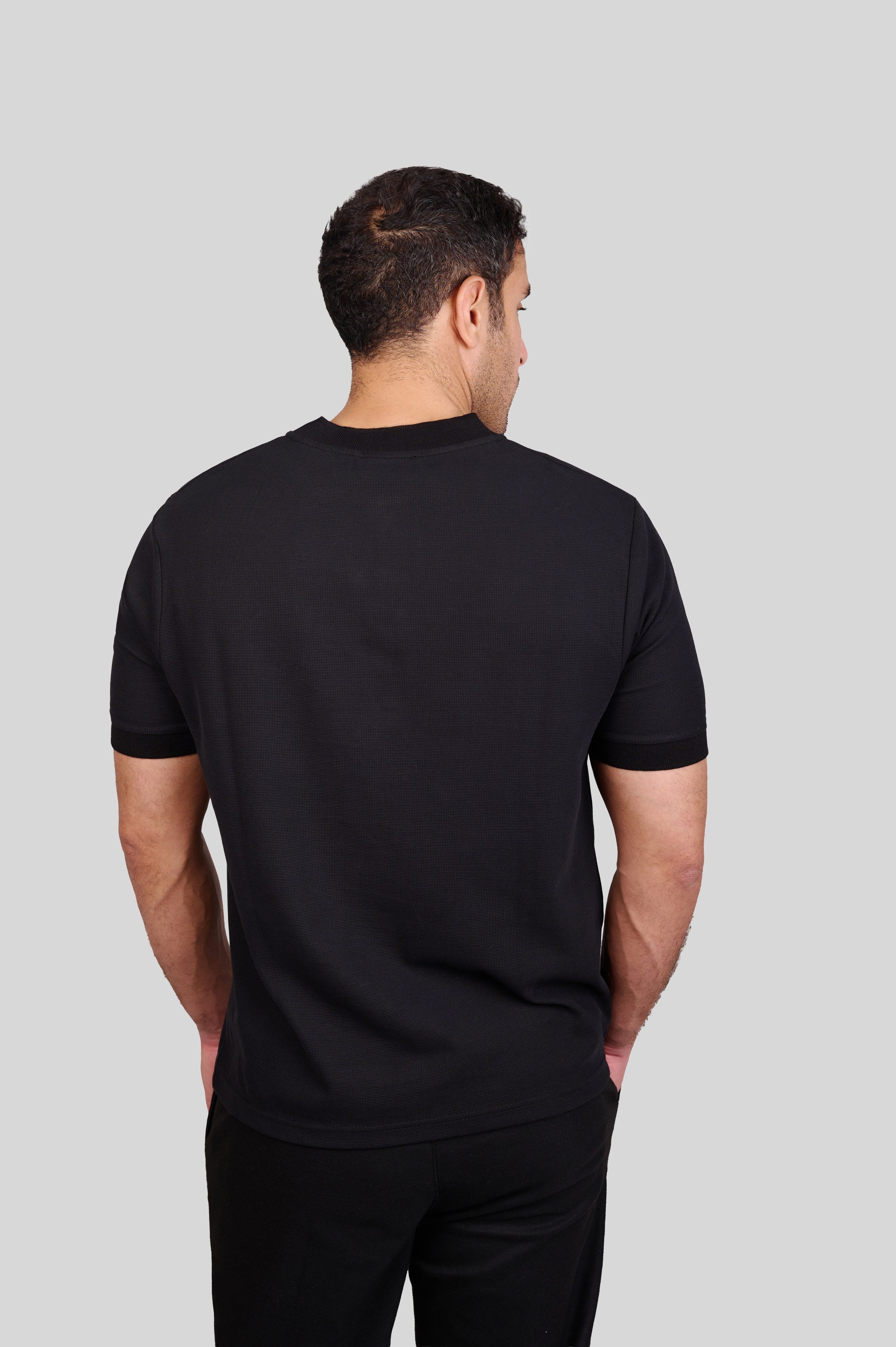 Rflx waffle-knit mandarin collar henley tee in black, back view showing the plain body and ribbed collar