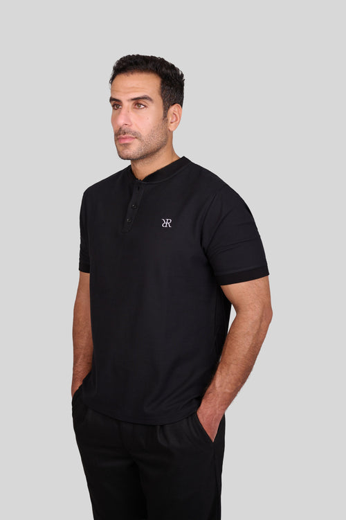 Rflx waffle-knit mandarin collar henley tee in black, front view worn with black trousers