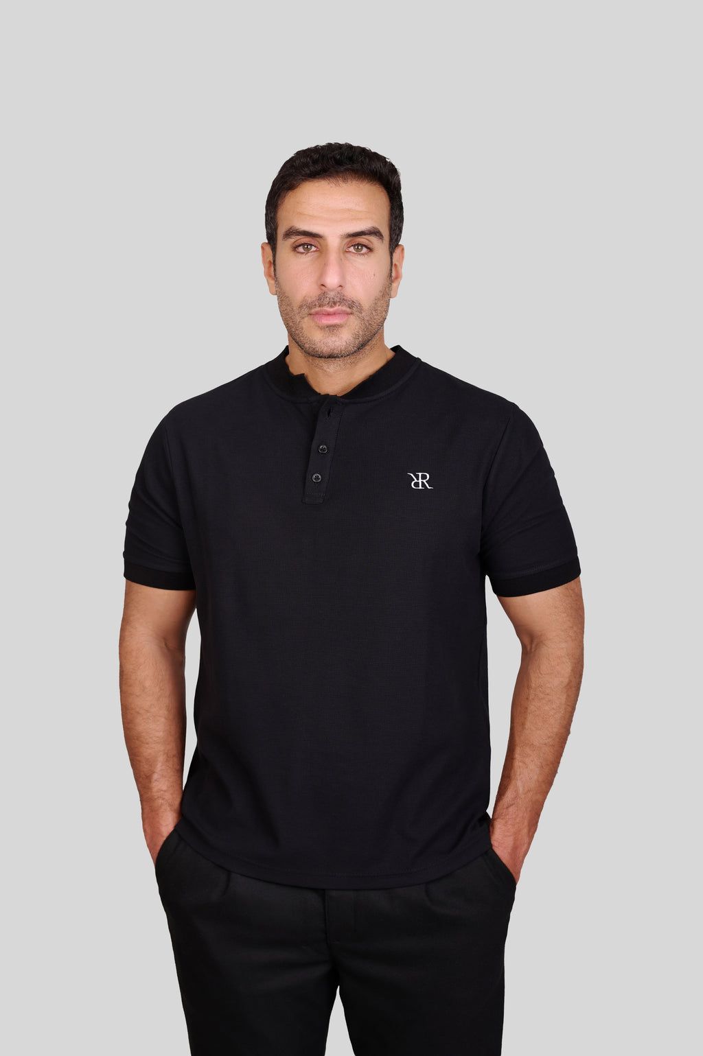 Rflx waffle-knit mandarin collar henley tee in black, three-quarter view showing the shoulder and sleeve