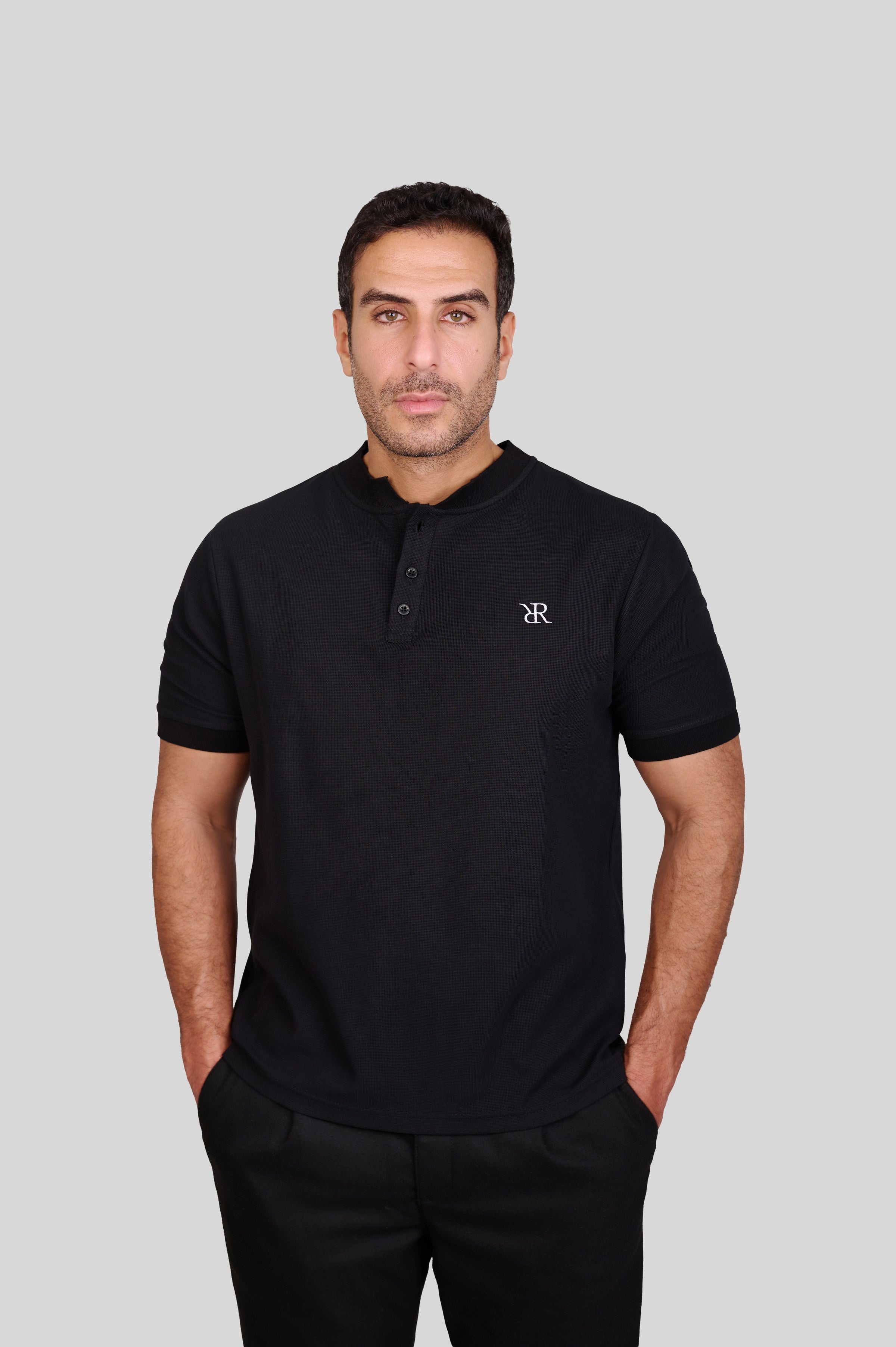 Rflx waffle-knit mandarin collar henley tee in black, three-quarter view showing the shoulder and sleeve
