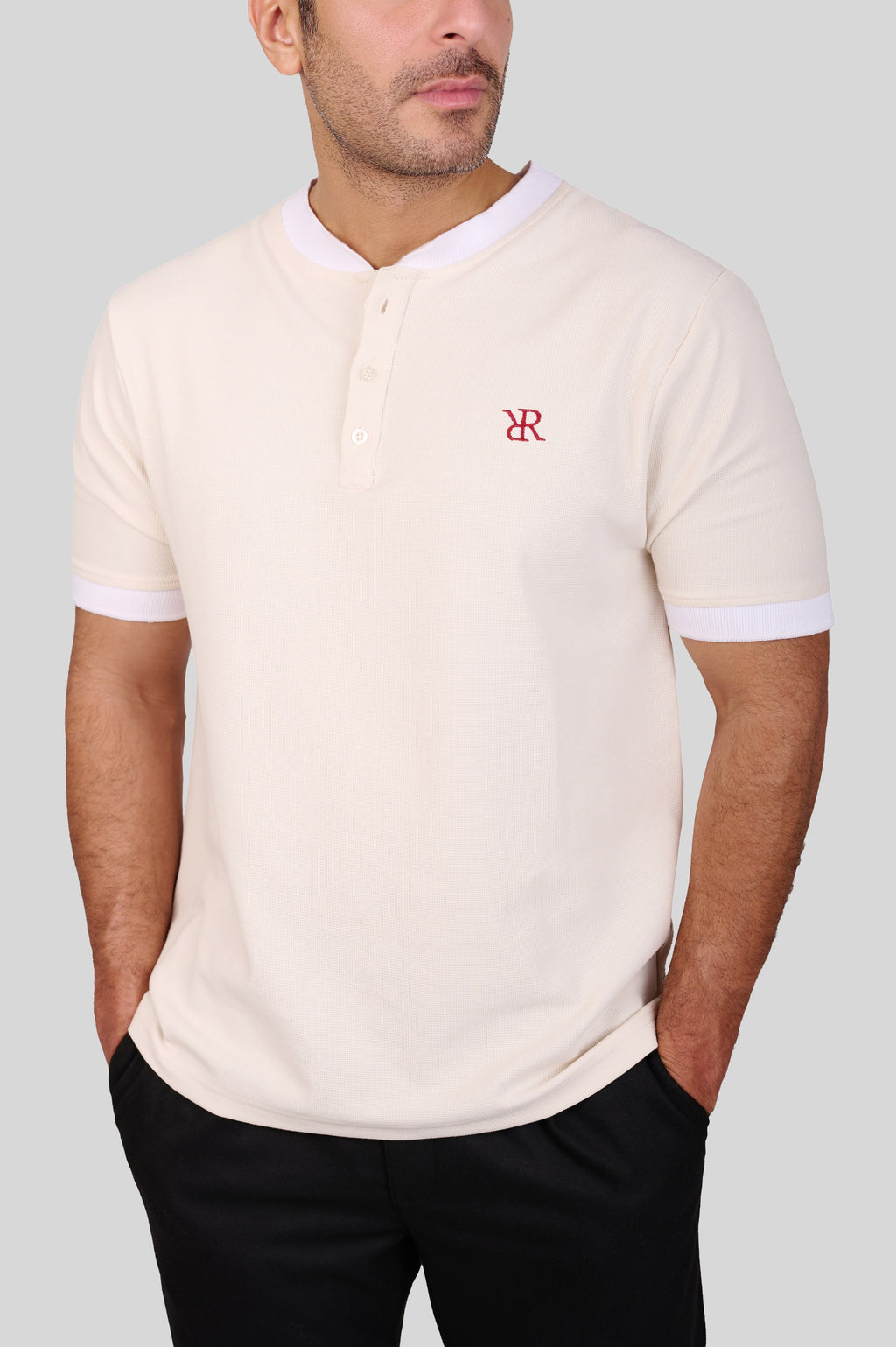 Rflx waffle-knit mandarin collar henley tee in cream with white ribbed trim, close view of the waffle texture, two-button placket and chest monogram