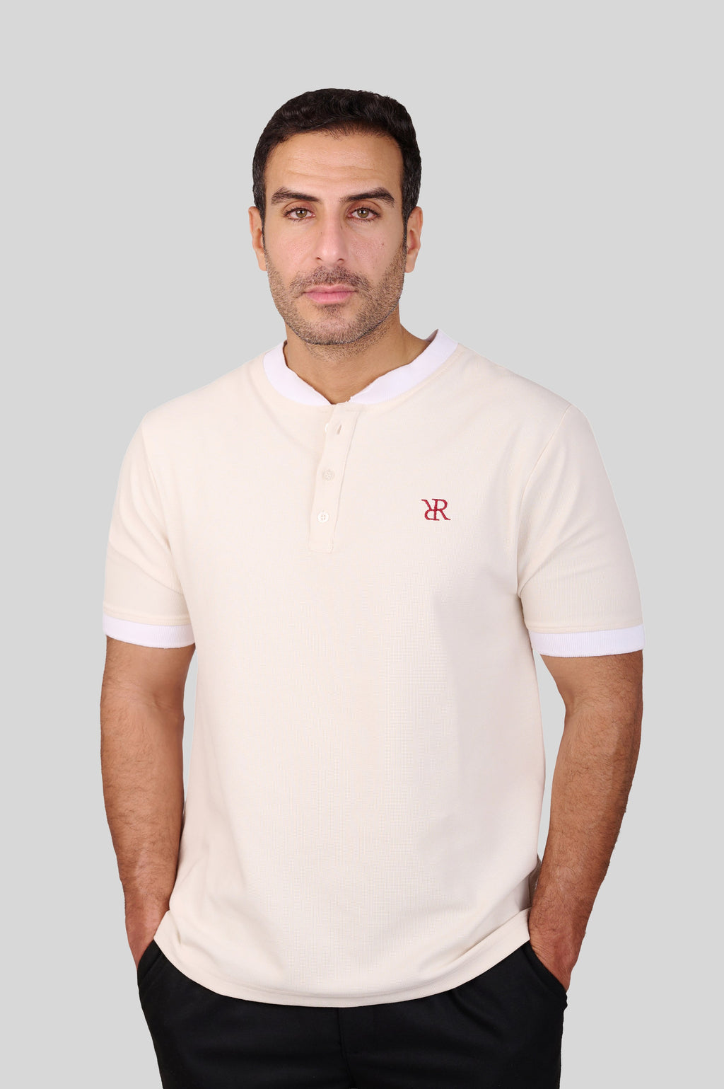 Rflx birdseye knit mandarin collar henley tee in cream with white ribbed trim, front view worn with black trousers