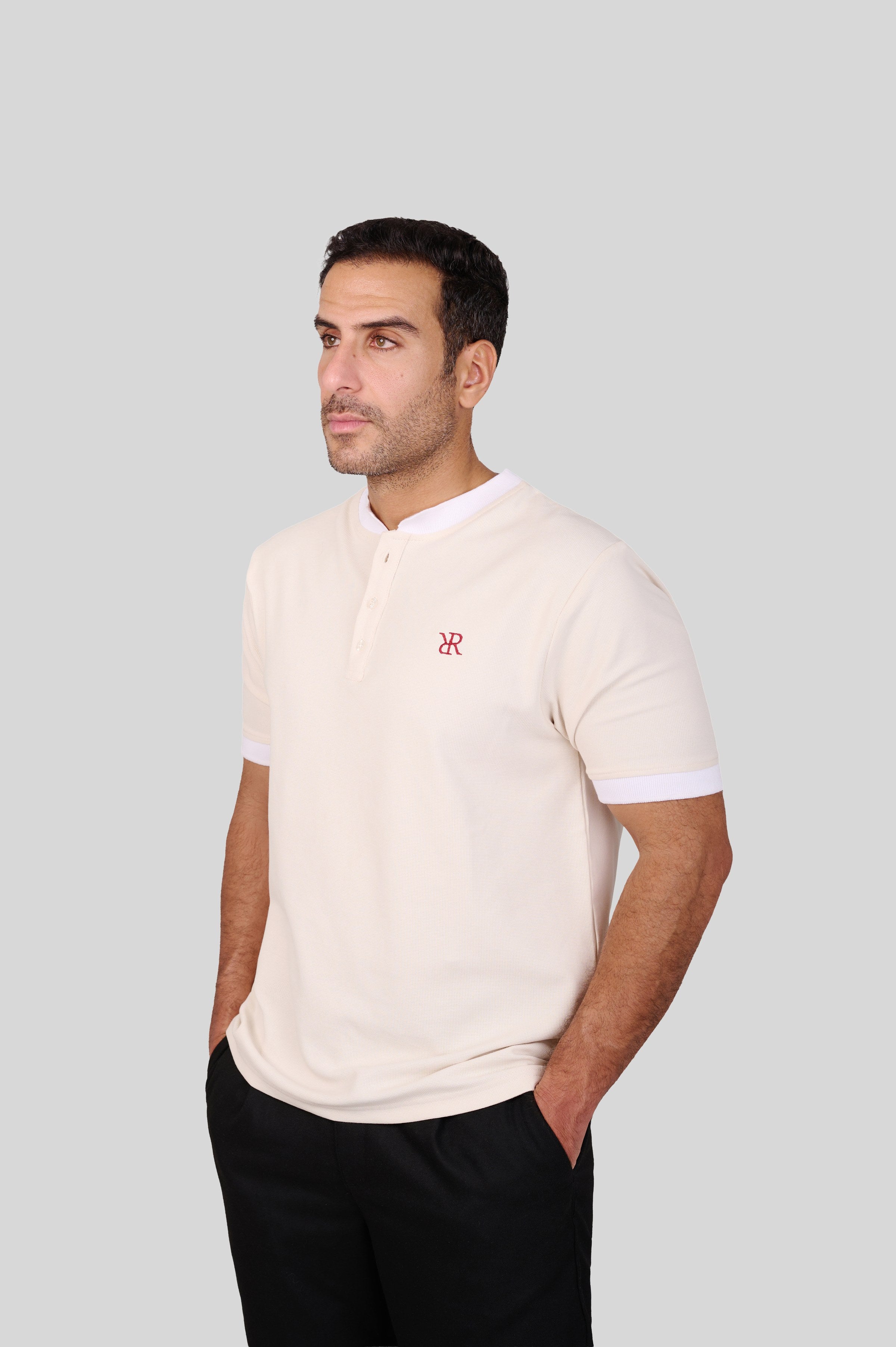 Rflx waffle-knit mandarin collar henley tee in cream with white ribbed trim, three-quarter view showing the shoulder and sleeve