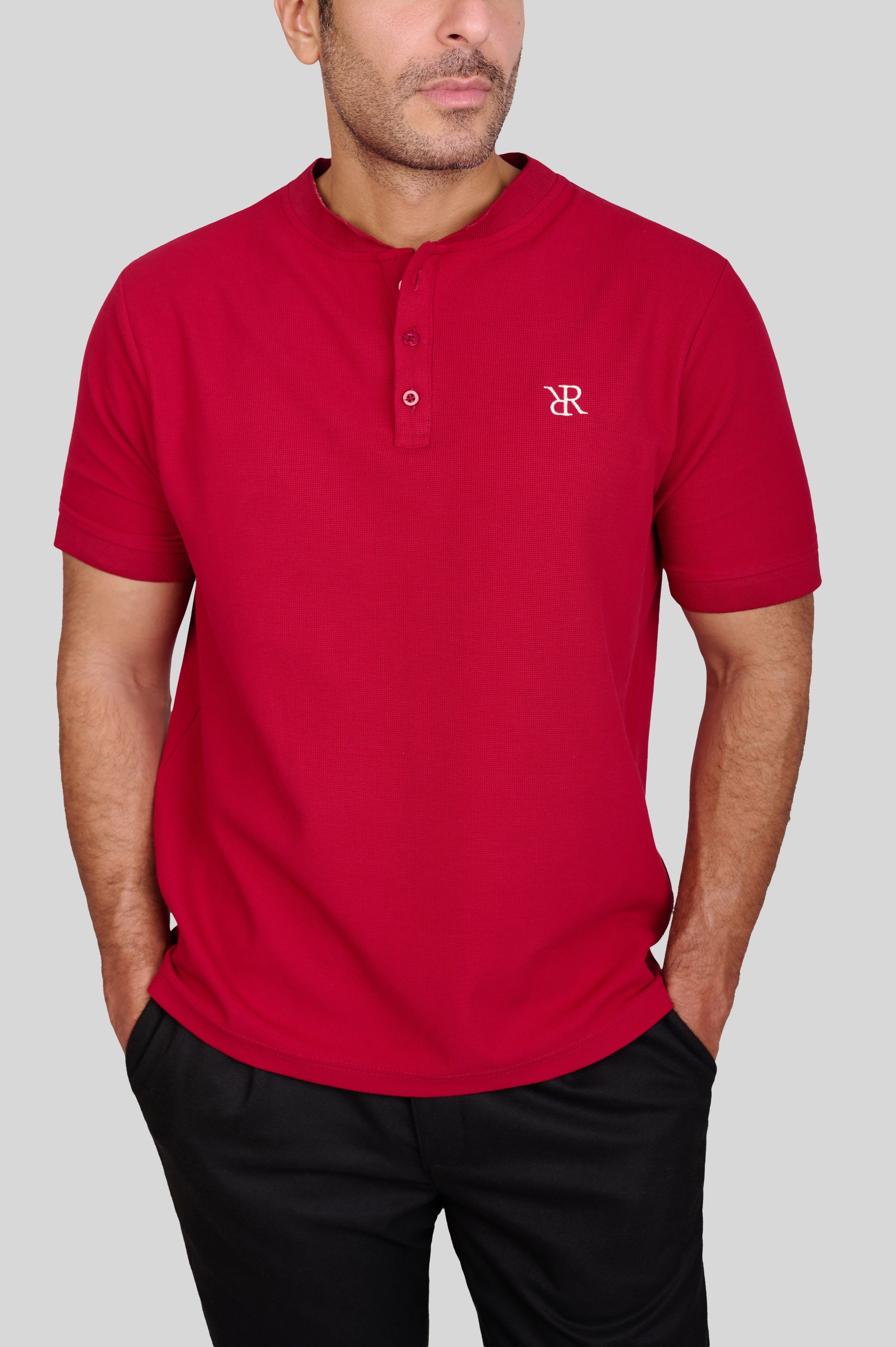 Rflx waffle-knit mandarin collar henley tee in crimson, close view of the waffle texture, two-button placket and chest monogram