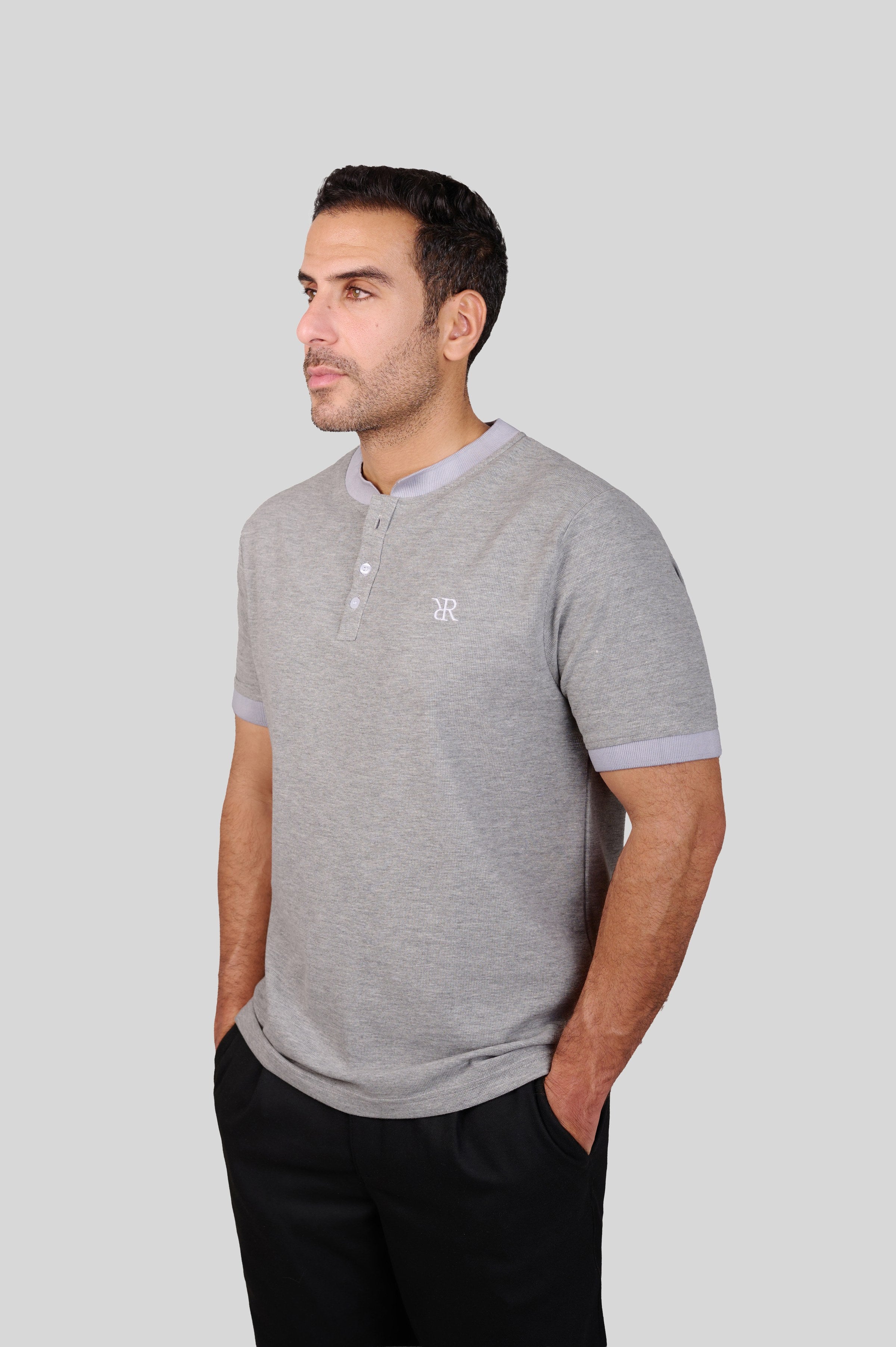 Rflx waffle-knit mandarin collar henley tee in heather grey with lilac ribbed trim, three-quarter view showing the shoulder and sleeve